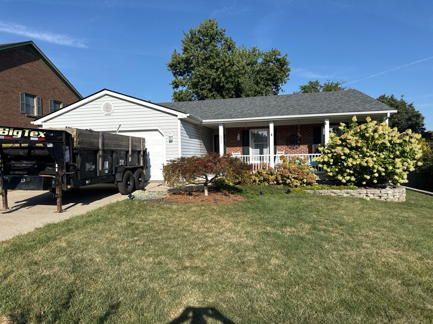 Completed residential roof on a brick ranch home